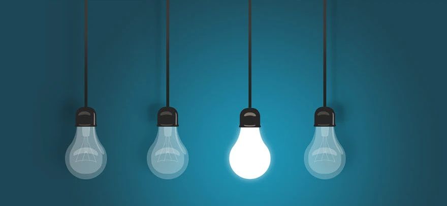 Four hanging light bulbs, one lit
